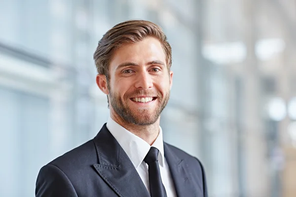 depositphotos_97431594-stock-photo-businessman-smiling-confidently-at-camera